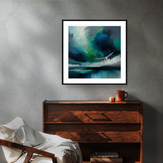 Seabird wildlife art black framed limited edition print by Natalie Jump. A white seagull extends its powerful wings, cutting through a dramatic stormy sky.