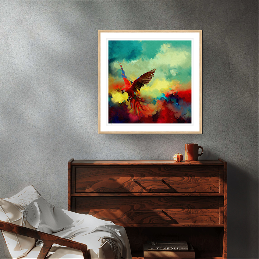 Tropical Drift wildlife oak framed limited edition art print by Natalie Jump. A vibrant explosion of colour and motion, a macaw is captured mid-flight, its wings extended in a burst of reds, golds and electric blues.