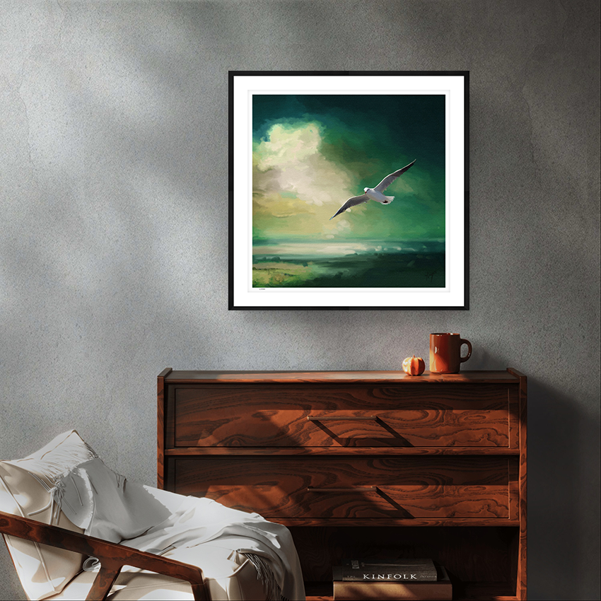 Glide wildlife art black framed limited edition print by Natalie Jump. A lone seagull glides effortlessly across a deep sea green sky. 