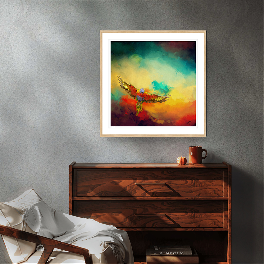 Lorikeets Flight wildlife art oak framed limited edition print by Natalie Jump. A vibrant sky with swirling cloud like textures of red, yellow and green. In the foreground a lorikeet bursts  into flight.