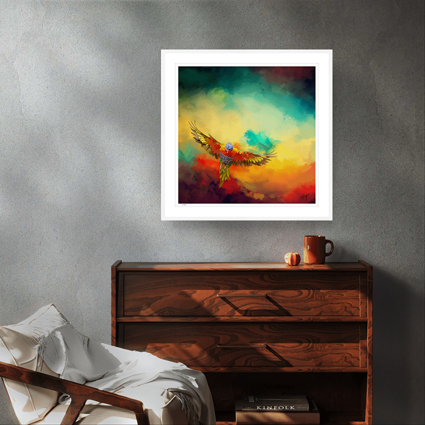 Lorikeets Flight wildlife art white framed limited edition print by Natalie Jump. A vibrant sky with swirling cloud like textures of red, yellow and green. In the foreground a lorikeet bursts  into flight.