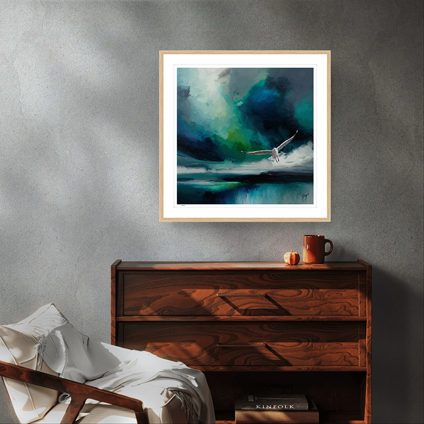 Seabird wildlife art oak framed limited edition print by Natalie Jump. A white seagull extends its powerful wings, cutting through a dramatic stormy sky. 