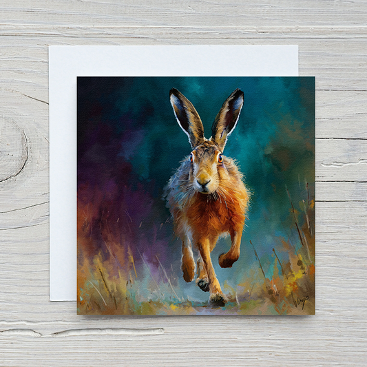 Twilight Sprint wildlife art greetings card by Natalie Jump. A hare bounding through a field at dusk, silhouetted against a deep turquoise and purple sky.